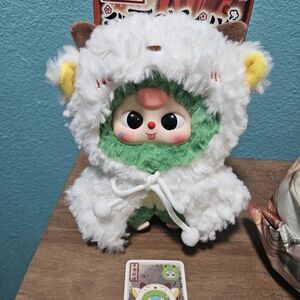 Plush Green-Faced Doll in White Furry Animal Hood